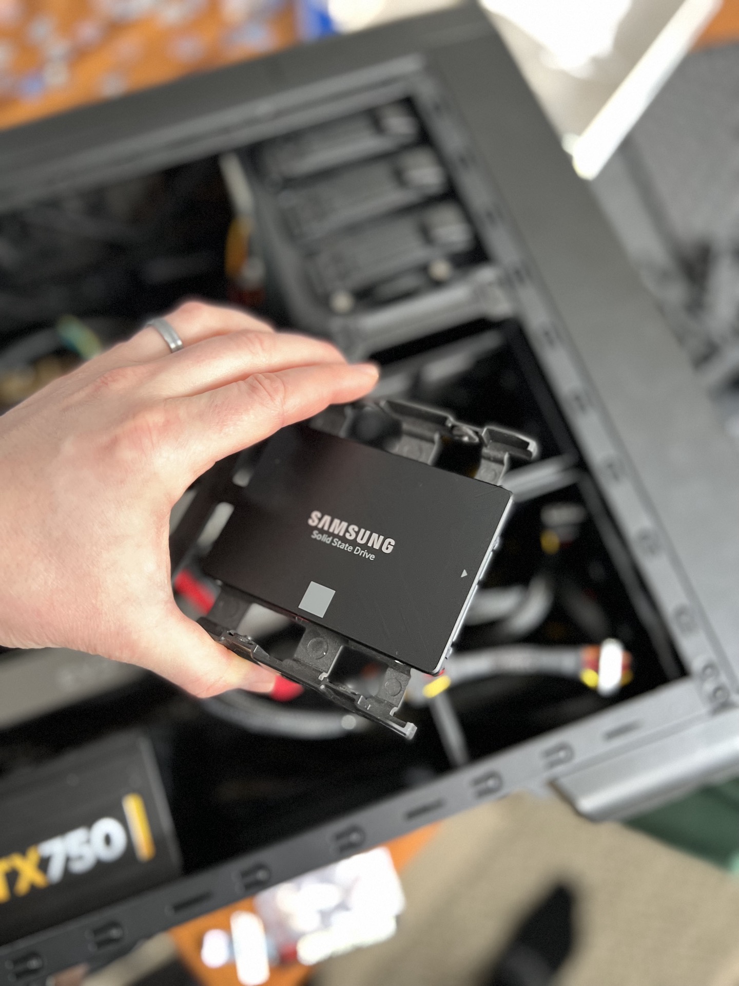 A solid-state drive being installed during a computer repair